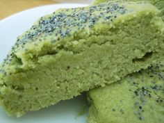 two pieces of green cake on a white plate with sprinkles around it