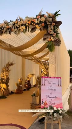 an outdoor wedding venue decorated with flowers and greenery