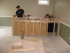 a man standing in a room under construction