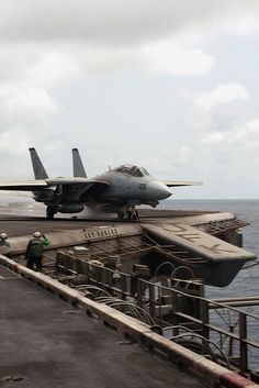 a fighter jet sitting on top of an aircraft carrier