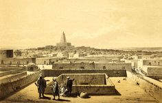 an old photo of some people standing in the middle of a town with a tower