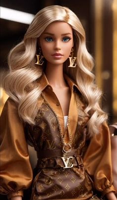 a barbie doll with blonde hair wearing a brown dress and gold earrings on her head