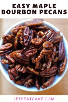 a white bowl filled with pecans on top of a wooden table and text overlay that reads easy maple bourbon pecans