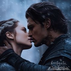 a man and woman kissing in the rain with snow falling all around them, as if they were from game of thrones