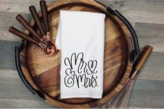 a white dish towel with the words mr and mrs on it next to some whisks