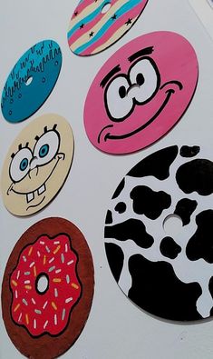 several different colored donuts with faces painted on the front and back of each one