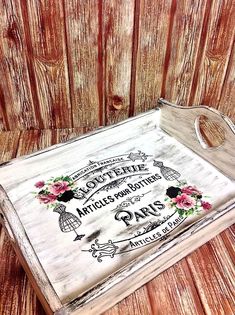 an old wooden tray with some writing on it