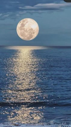 the full moon shines brightly over the ocean as it reflects off the water's surface