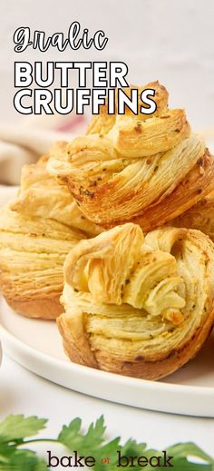 three puff pastry on a white plate with parsley sprigs in the background