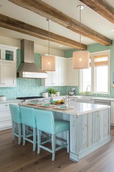 a large kitchen with an island in the middle and blue chairs at the counter top