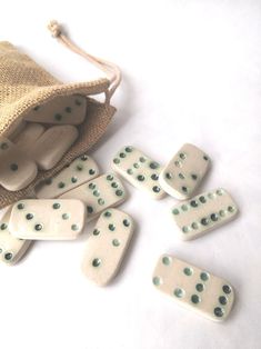 several dominos are laying on the ground next to a bag with some dice in it