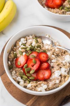 two bowls filled with oatmeal and strawberries