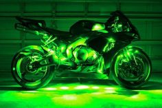 a motorcycle that is glowing green in the dark