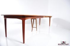 a wooden table sitting on top of a white floor