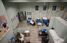 an aerial view of a hospital room with beds and desks