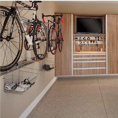 a garage with lots of bikes hanging on the wall and storage space in front of it