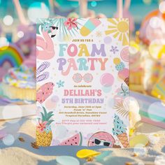 a birthday party with pineapples, watermelon and flamingos on the beach