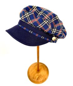 Classic and elegant blue tartan plaid sailor cap. Adorned with a ribbon of the same fabric as the visor and riveted with metallic buttons in old silver color. 65 % polyester 35% linen. Cut and sewn on the bias with a quality tartan plaid fabric and finished with a very light cotton lining. The length of the visor is 4.5 centimeters. The back of the cap has a small eco-leather belt to adjust the measurement up to three centimeters less. It adapts very well to the head. For its production we use t Navy Cotton Brimmed Hat, Navy Brimmed Casual Sun Hat, Casual Navy Brimmed Sun Hat, Navy Adjustable Baseball Cap For Summer, Adjustable Navy Baseball Cap For Beach, Navy Cotton Visor Hat, Blue Brimmed Cotton Baseball Cap, Blue Cotton Brimmed Baseball Cap, Navy Visor Hat For Summer