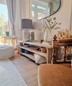 a living room filled with furniture and a large mirror