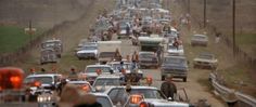 many cars and trucks are stuck in traffic on the road as people walk down the street