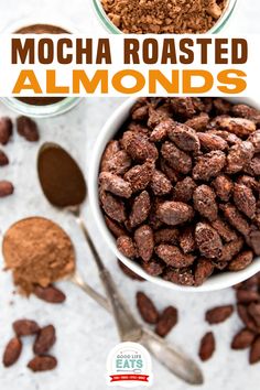 a bowl filled with chocolate almonds next to two spoons and some cocoa powder