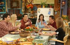 a group of people sitting around a table eating food