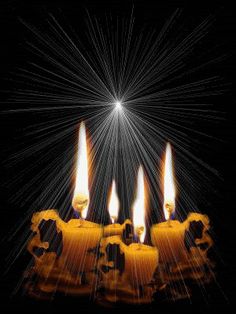 a group of lit candles sitting in the middle of a black background with white stars