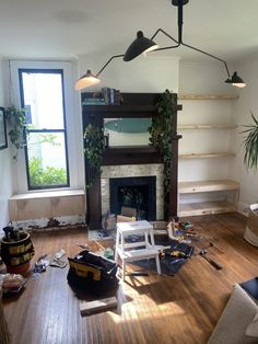 a living room filled with furniture and a fire place in the middle of a wooden floor