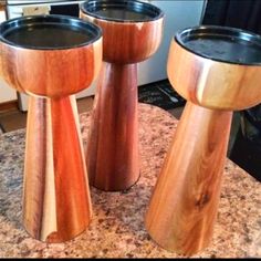 three wooden stools sitting on top of a counter