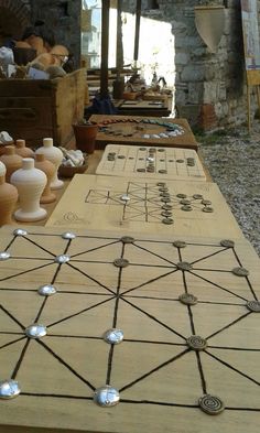 several vases are sitting on top of a wooden table with wire and woodwork