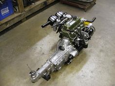 a motorcycle engine sitting on the ground in a garage