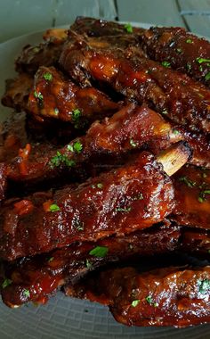 the ribs are covered in bbq sauce and garnished with parsley