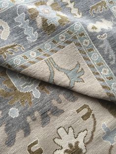 the fabric is blue and brown with an elephant design on it, as well as other patterns