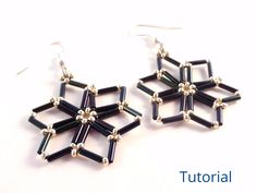 the earrings are made out of black glass and beaded with silver beads, on a white background