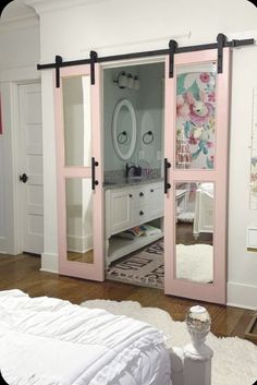 a bedroom with pink sliding doors and floral wallpaper