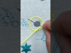 someone is stitching something on the side of a piece of fabric