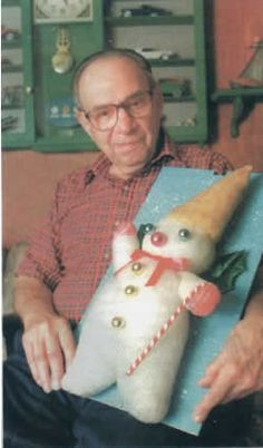 an older man is holding a stuffed animal