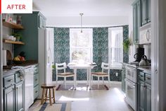 a kitchen with green and white wallpaper and wooden chairs in the middle of the room