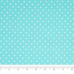 a ruler is next to a blue and white polka dot fabric