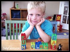 a young boy sitting at a table with blocks spelling out the word'fun '