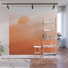 an orange and pink wall mural in a living room with a ladder leaning against the wall