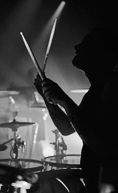 black and white photograph of drummer playing drums