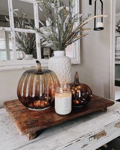 two pumpkins sitting on top of a wooden table