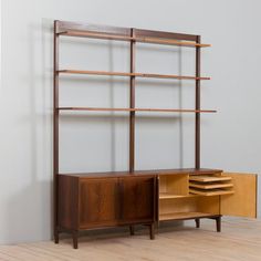 a wooden shelf with drawers and shelves on it