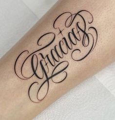 a tattoo with the word grace written in cursive writing on it's arm