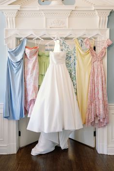 there are many dresses hanging on the rack