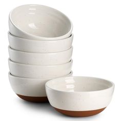 a stack of white bowls sitting next to each other