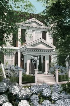 a white house surrounded by blue flowers and greenery in the foreground is an iron fence