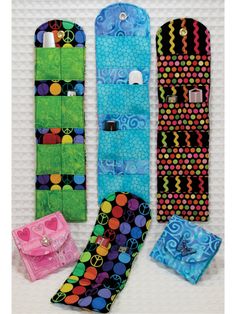 four different colored skateboards hanging on a wall with one attached to the board and two are made out of fabric