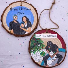 two wooden ornaments with the words merry christmas and an image of a man and woman